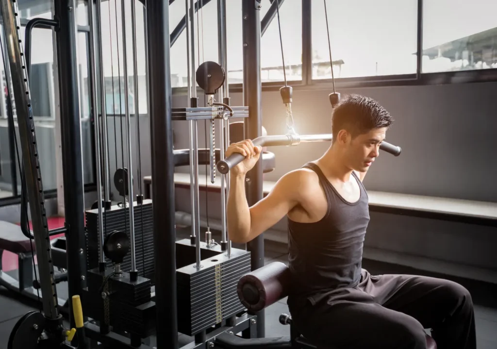 Resident working out on a weight machine in the fitness center at 626 On The Park