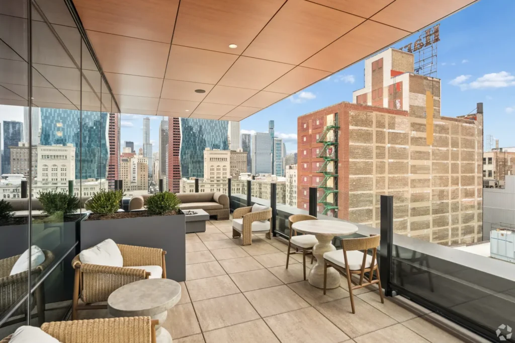 Rooftop terrace with lounge seating, grilling stations, planters, and views of downtown Chicago.