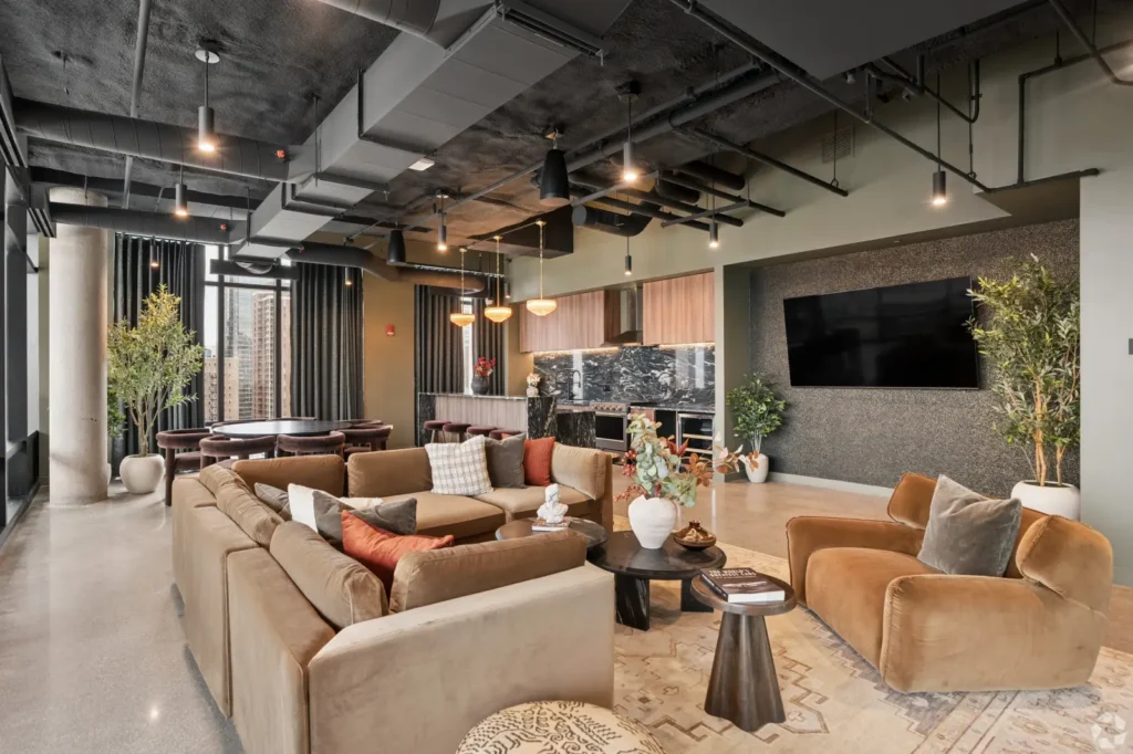 Private conference room with a long table, leather chairs, abstract wall art, and a display screen.
