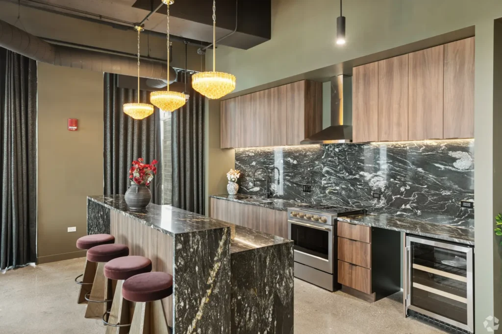 Private meeting room with a long wood table, leather chairs, wall-mounted screen, and glass partition.
